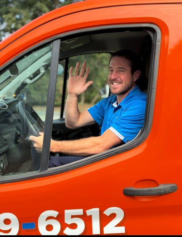 Guardian technician waving from a service van